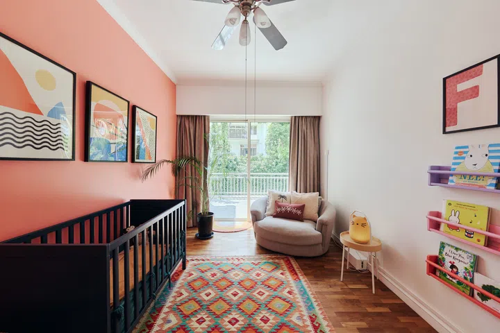 Lotte painted the navy blue cot herself and customised the colourful wall-mounted bookshelves, proving that simple  IKEA pieces can be transformed with a little paint and imagination.