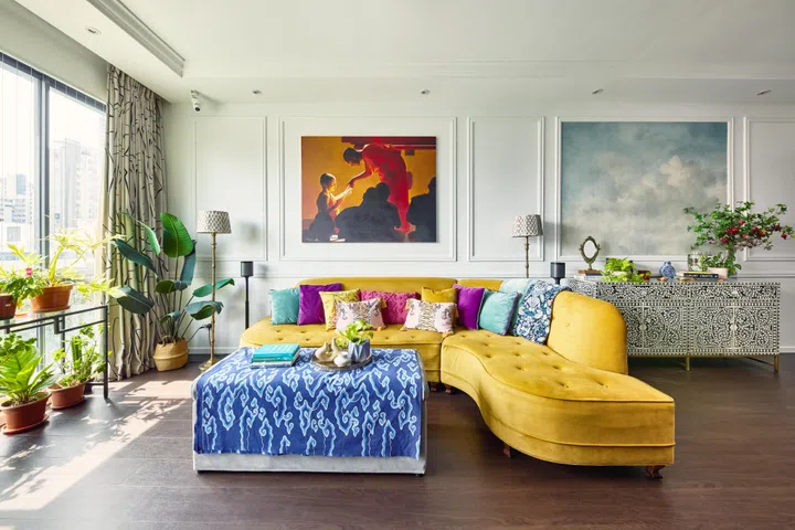 A custom-built velvet mustard couch in the living room of a 3-bedroom condo along Balestier Road.