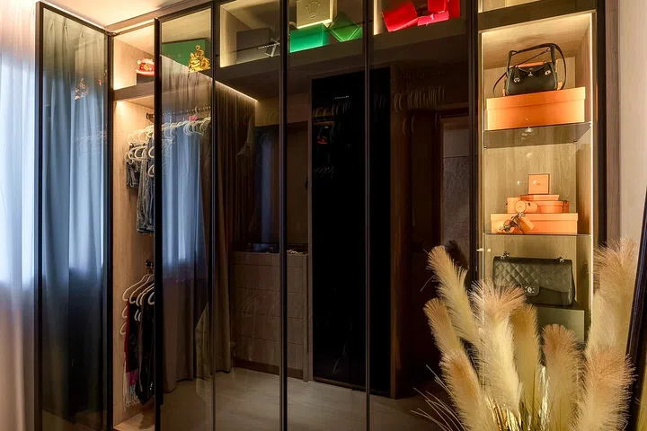 Glass cabinetry showcases the couple’s collections while concealing everyday storage.