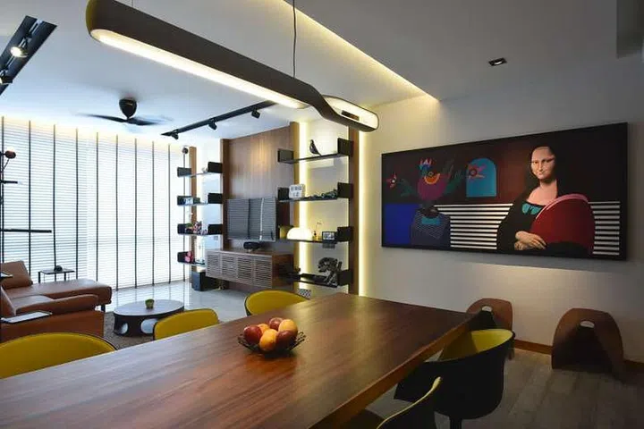 A six-seater wood table (above), the centrepiece in the dining room, lets the family of four lounge around the dining table while they watch television.