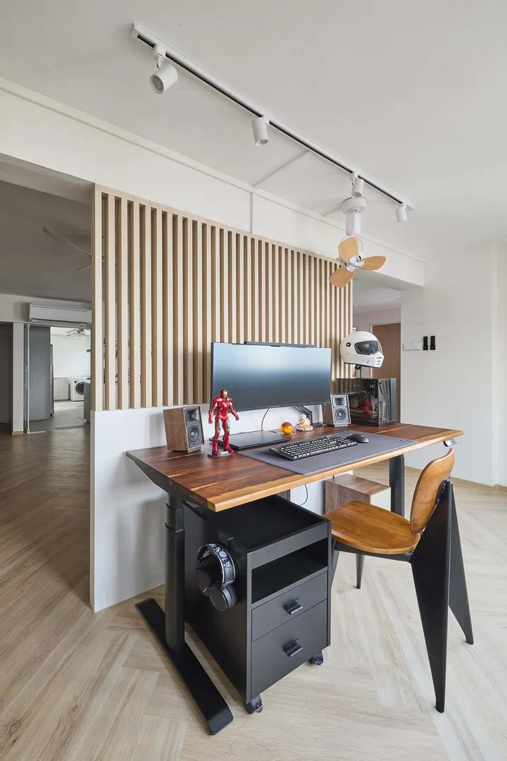 Privacy screen demarcates a work station in the living room of this 5-room HDB in Hougang.