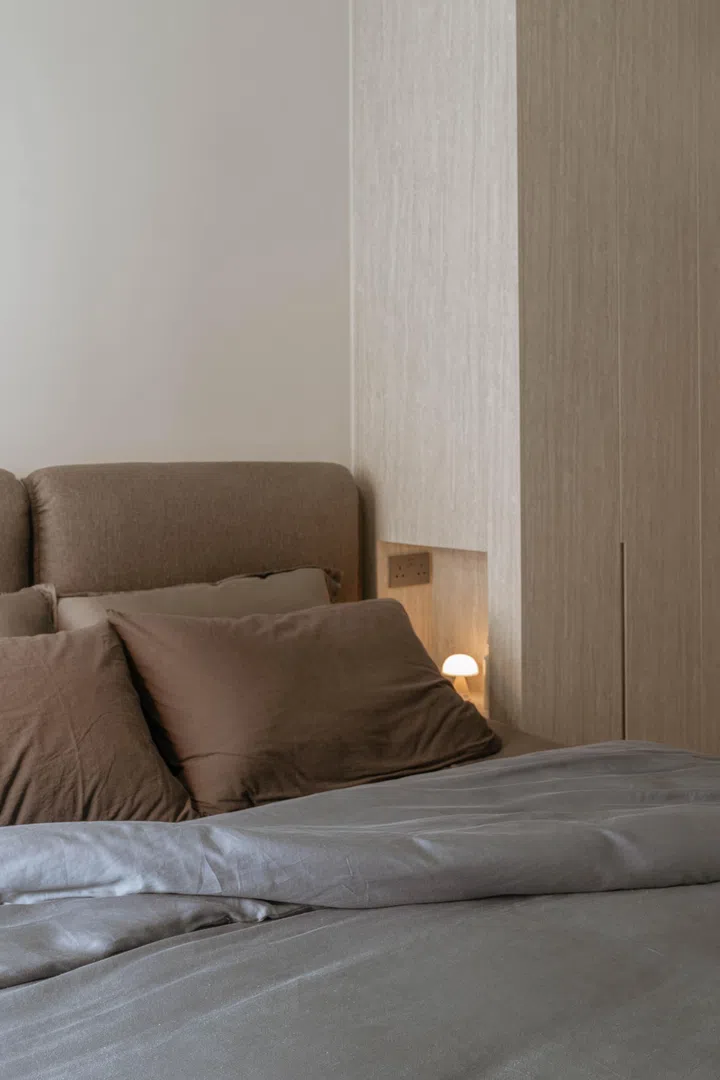 The homeowners designed a small niche at bedside height, complete with charging points and a hidden LED light switch for the wardrobe light. 