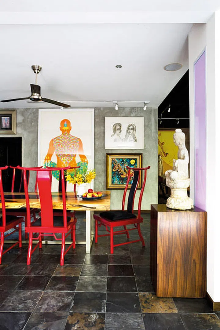 All of the lacquered furniture in the home, like these red dining chairs, are from Bali-based furniture manufacturer, Cempaka.