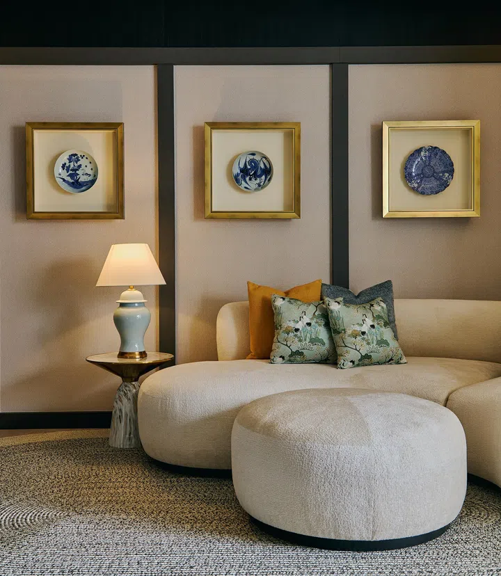 A bespoke sofa in neutral tones enhances the warm, tactile palette of the living space.