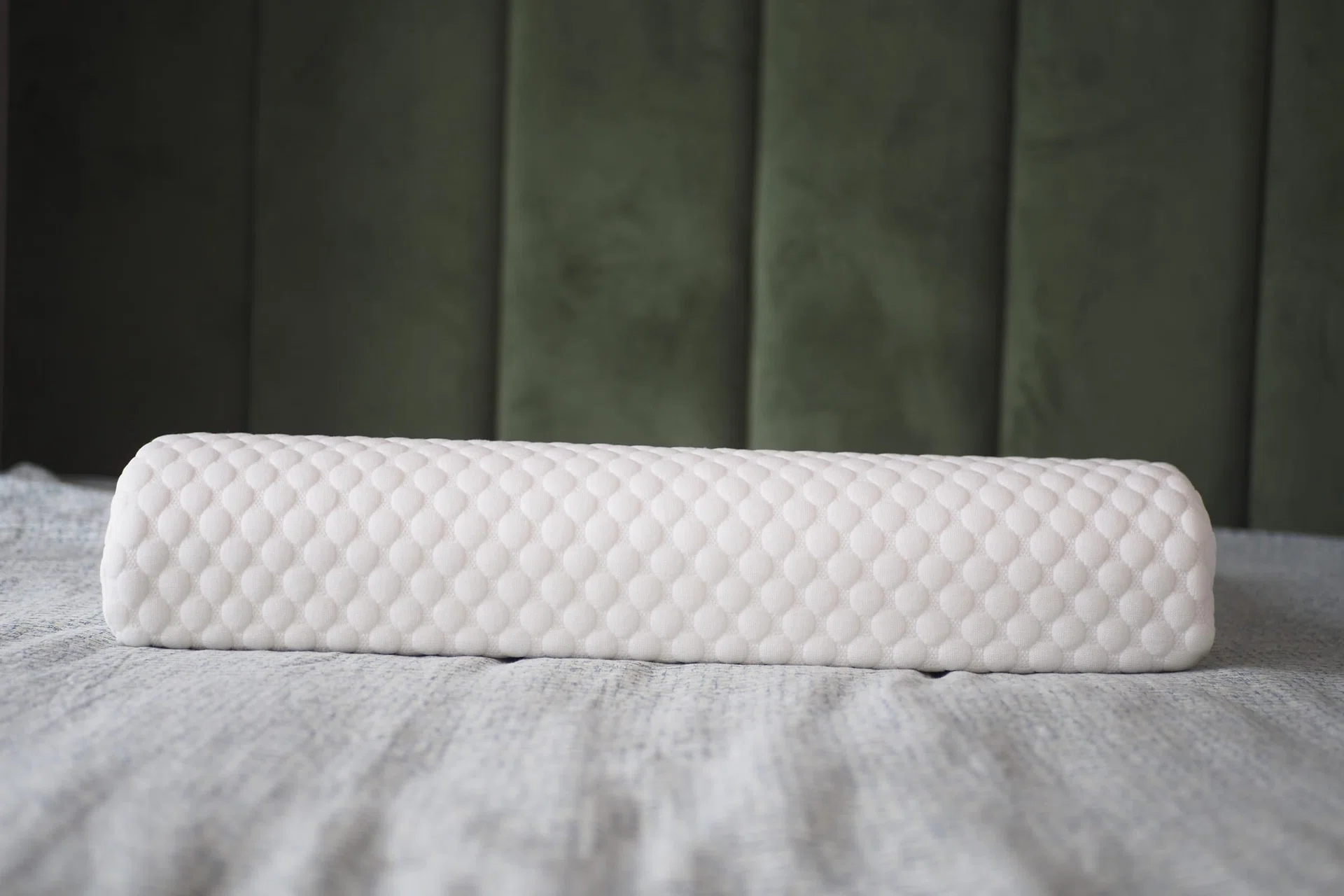 Orthopedic pillow on a bed.