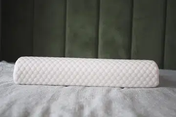 Orthopedic pillow on a bed.