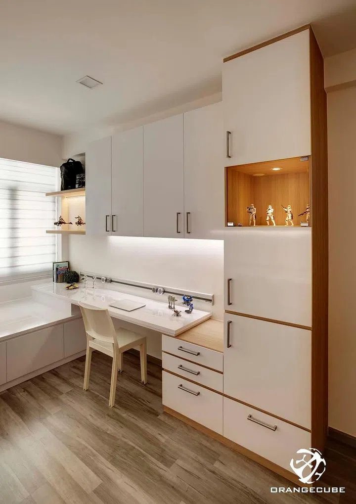 The bay window ledge was extended to create an adjacent study table in this condominium unit at Chestervale. Interior design by The Orange Cube.