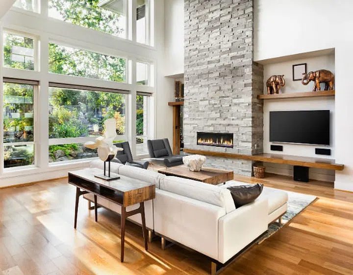 a stylish living room with a white sofa and television