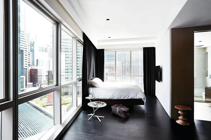 The master bedroom was the result of merging two bedrooms. Joel's bed lies on a Mudian customised frame that has integrated power points.