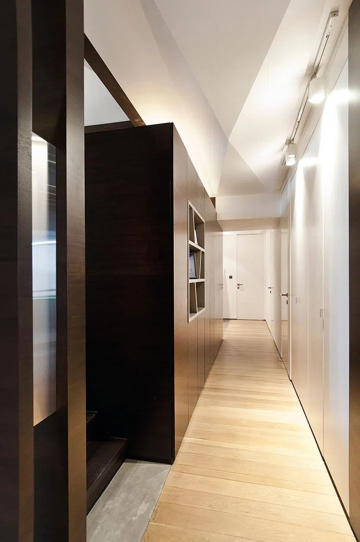 The bedroom doors are flush against the wall in the corridor, adding impact to the dramatic facets of the ceiling.
