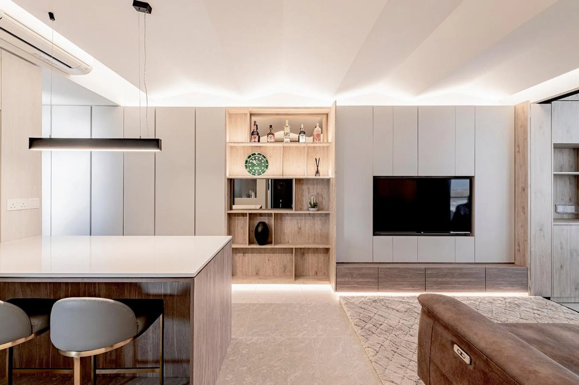 The living and dining area features plenty of storage space for items like shoes and luggage, tucked away out of sight behind the cabinet doors.