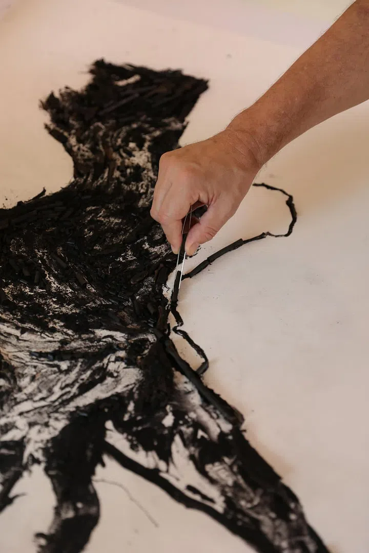 Flow Diptych was created from blackened wood and charcoal. 