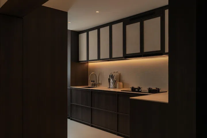 Viewed from the pantry, the kitchen remains partially tucked away while staying visually connected to the rest of the home—a balance between openness and order that Si Ling carefully planned.