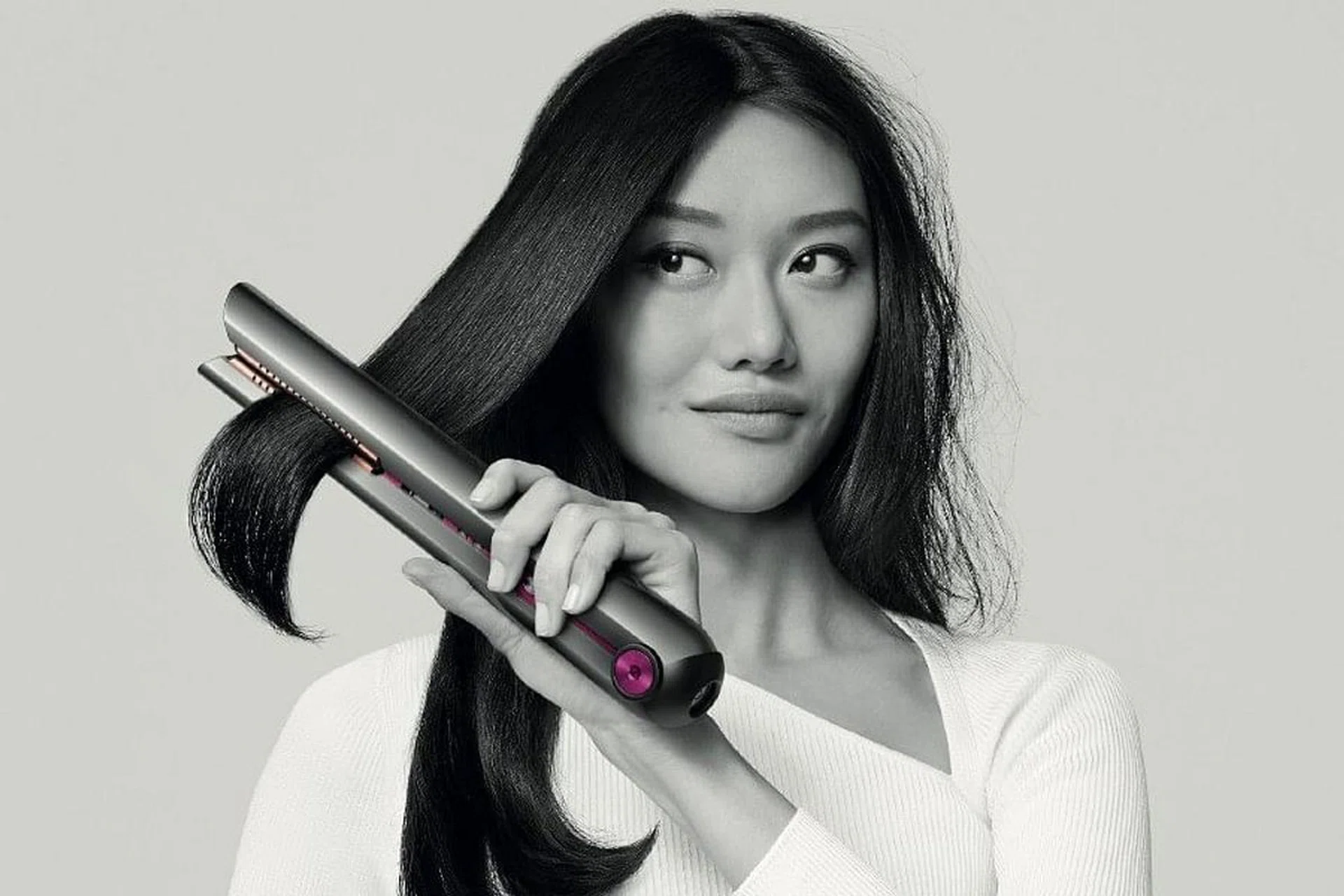 Female model using the Dyson Corrale Hair straightener