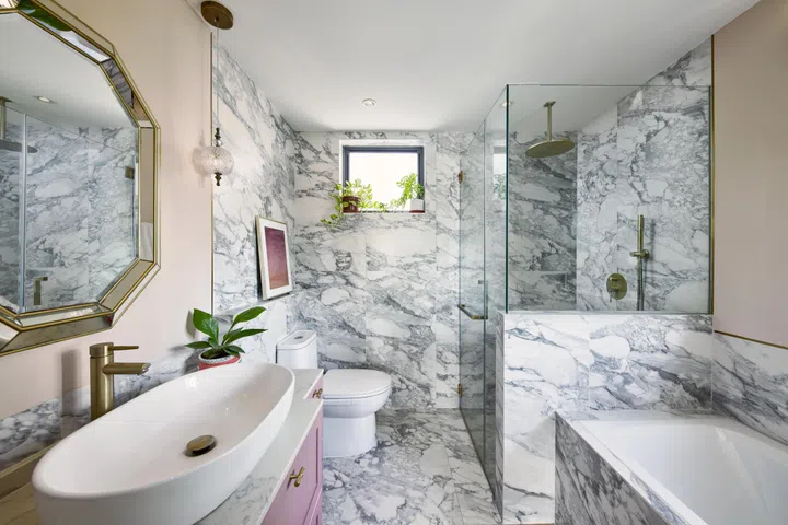 The master bathroom in this 3-bedroom condo along Balestier Road is fitted with grand, marble-effect tiles.