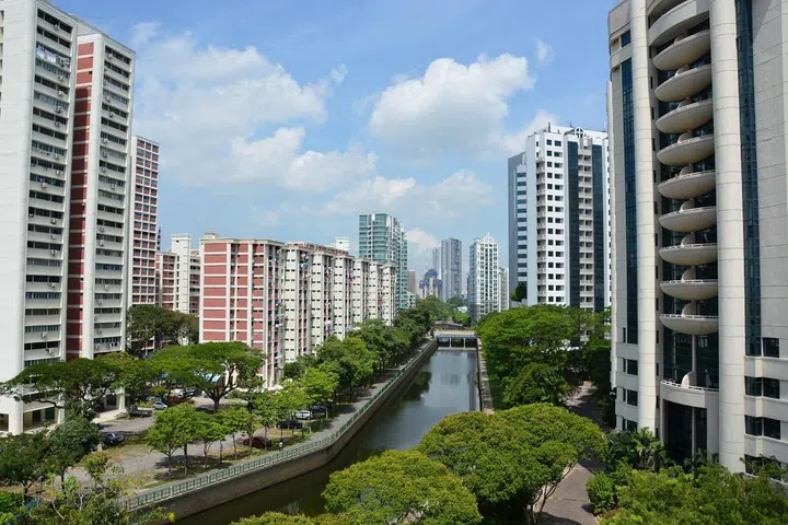 A canal surrounded by greenery and buildings