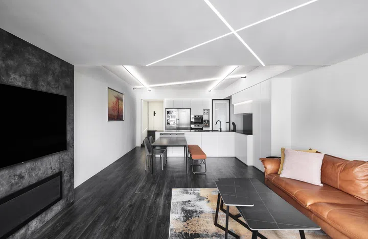 Graphic LED strips run across the ceiling, turning a practical lighting solution into a bold design statement.