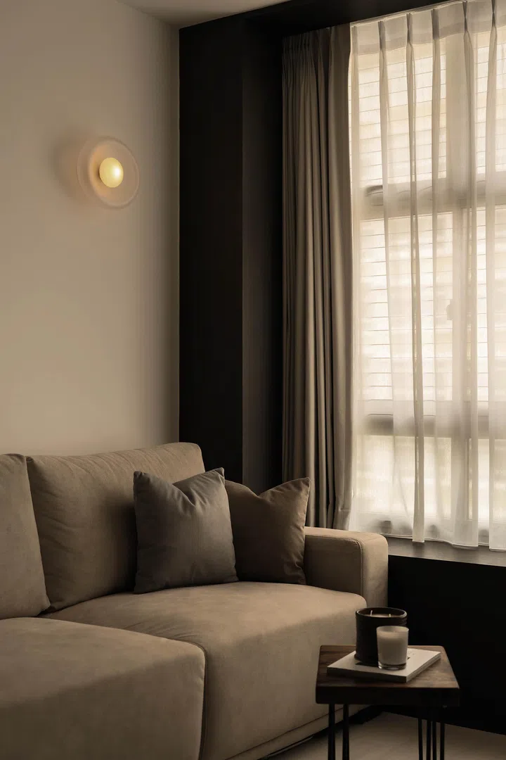  Soft lighting and muted tones give the living room a calm, serene quality—even when it becomes Andi’s late-night workspace.
