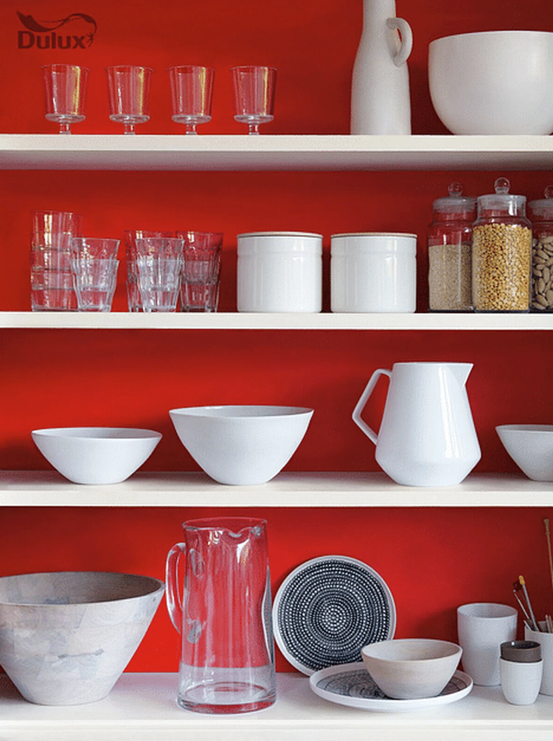 A bright chilli red wall paint background for open kitchen shelves. Image by Akzo Nobel.