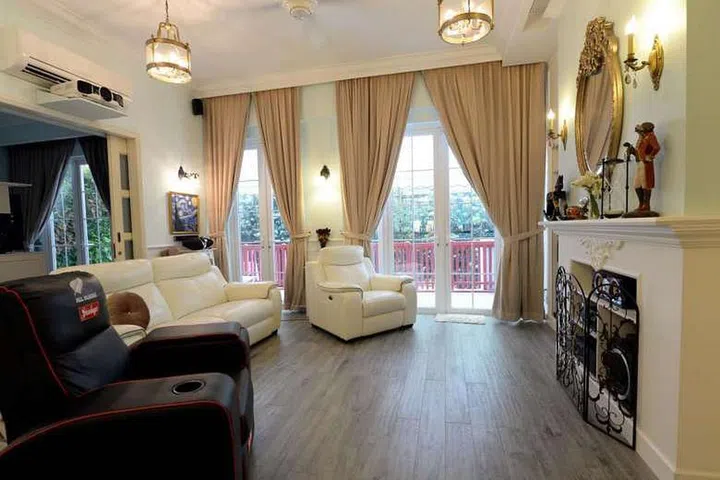 The homeowner's black recliner is a contrast to the other white furniture in the living room in this 2-bedroom ground floor condominium unit in Chelsea Lodge, along Tanjong Katong Road.