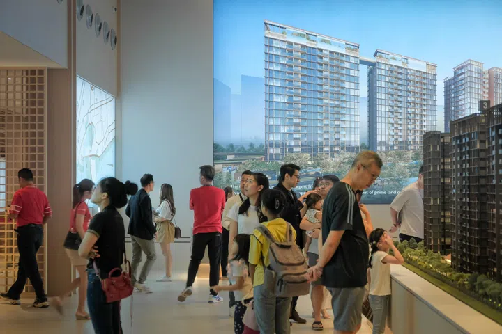 Potential buyers of The Continuum condominium looking at a model and having discussions at the show flat at Rose Lane, April 29, 2023.