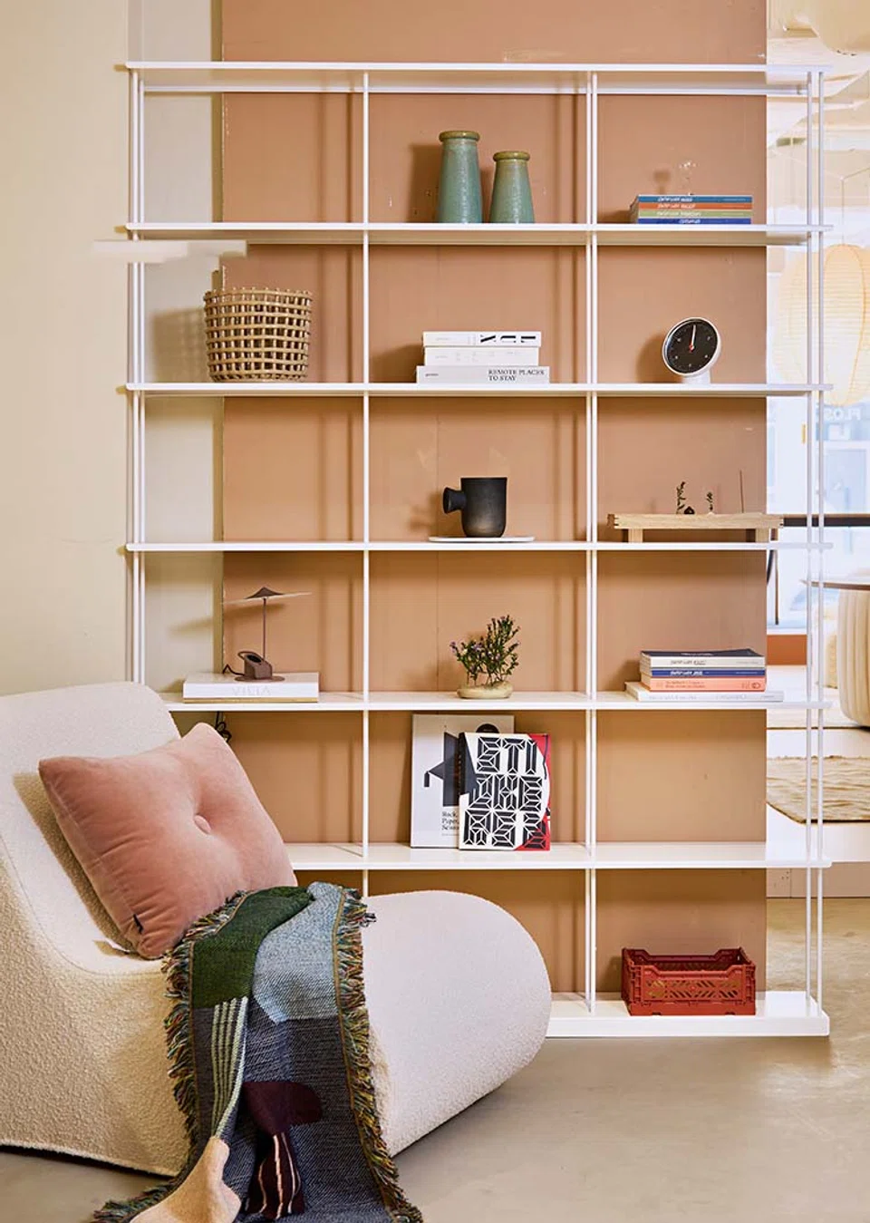 Reading corner with a sofa and an open shelving bookshelf.