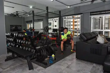 Mr Shahibul working out in his own home gym set up in his BTO HDB in Bukit Batok.