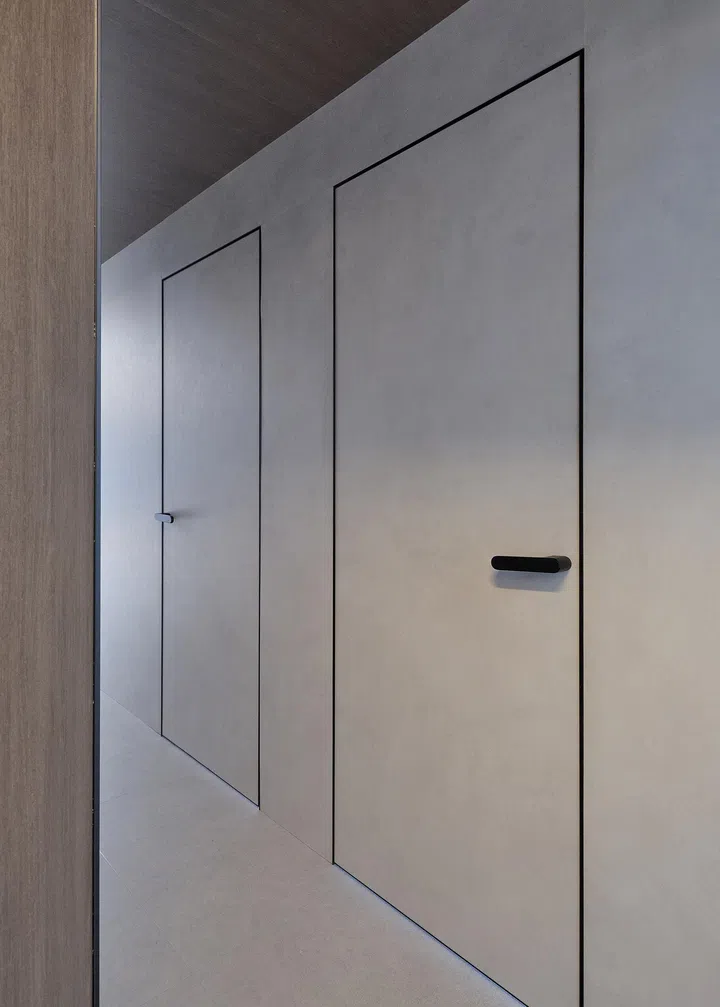 Frameless doors line the corridor.