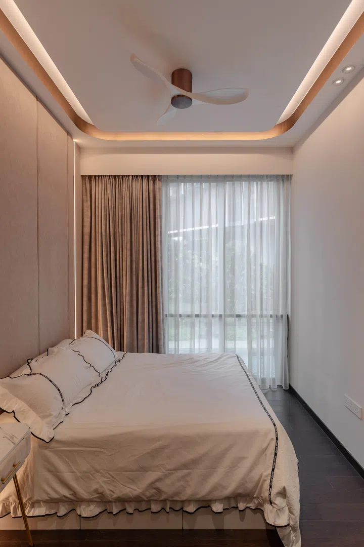 The master bedroom takes a softer approach, with integrated lighting, upholstered finishes, and warm material tones creating a calm retreat for rest and privacy.