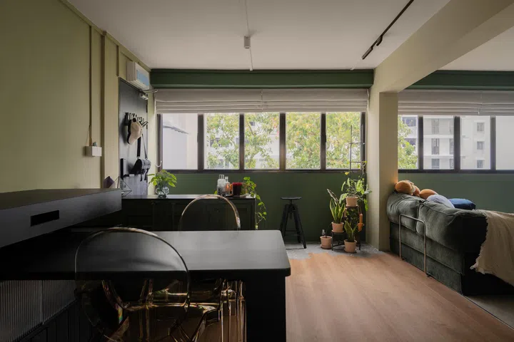 Sparsely furnished, the dining space doubles up as a workout zone, unified by the hexagon–vinyl floor pattern.