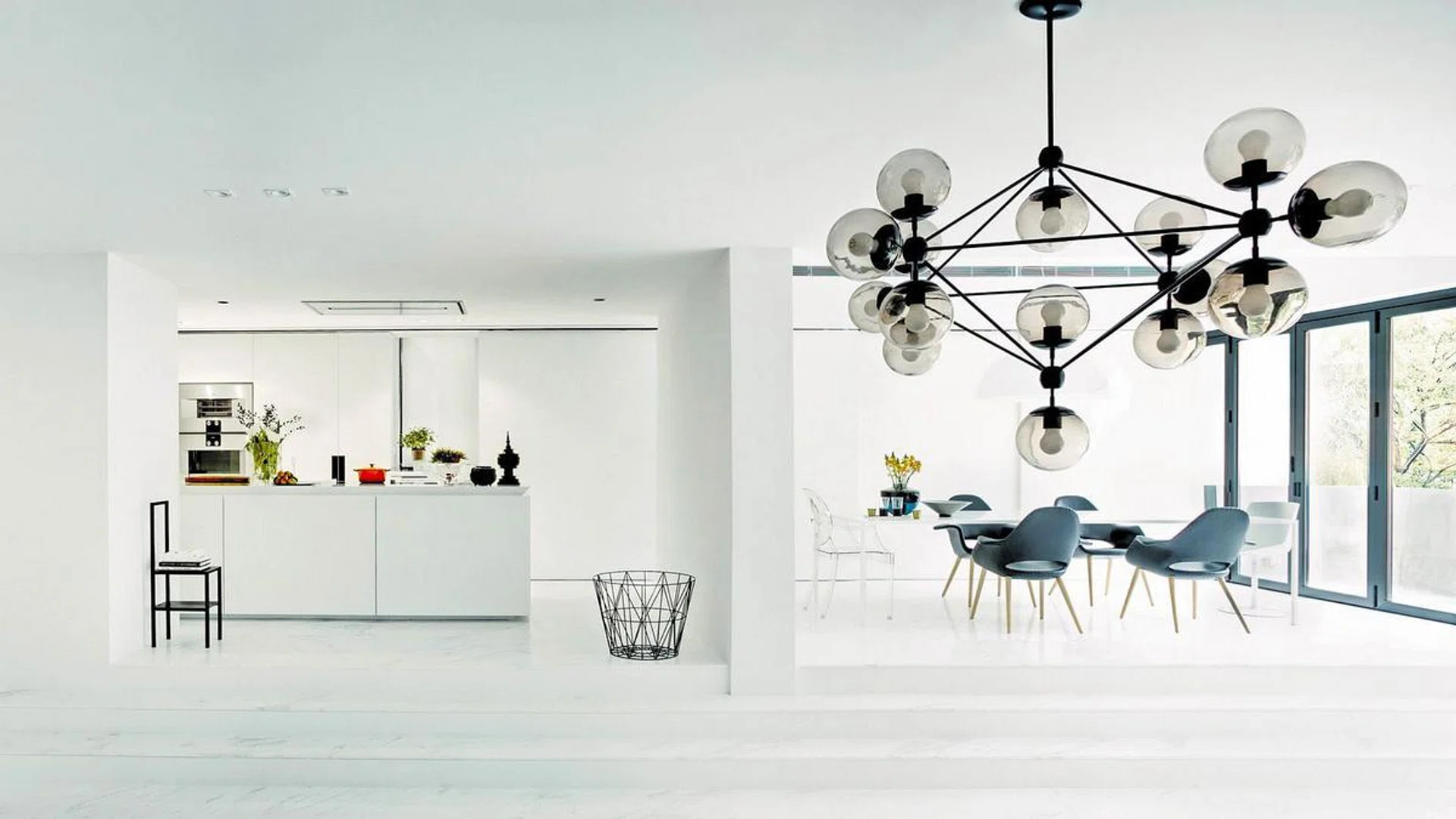 Dining room and kitchen in a black and white private apartment near Orchard Road.