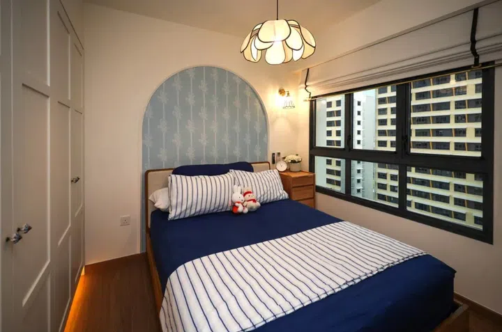 Lim’s bedroom features a soft arch design and warm lighting, giving the small space a calm, cosy feel..