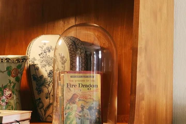 Well-loved childhood books are protected beneath glass, preserving cherished memories for years to come.