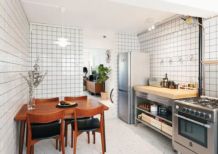 The terrazzo flooring flows from the living room to the dining and kitchen area.