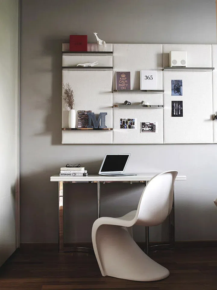 These luxurious-looking upholstered panels, what interior designer Matthew humbly calls ‘noticeboards’, allow the homeowner to tack on photos, posters and other items that display his personality in this bachelor's modern condominium in Novena.