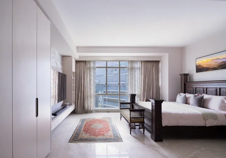 The hand-carved wooden bedframe, walk in wardrobe, and feature wall all contribute to the grandeur of the master bedroom in this 3-bedroom condo in Orchard Scotts.