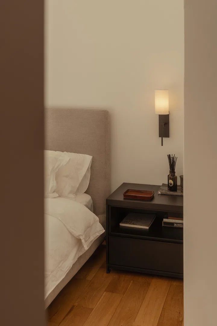 Subtle lighting and tactile finishes enhance the room’s quiet atmosphere.