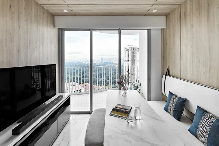 Living room sofa and dining table set up for an apartment within the Queens Peak condominium.