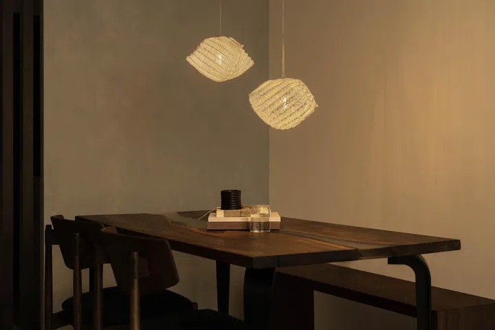  A dark walnut resin dining table became the home’s anchor piece, shifting the entire palette from light to moody Japandi.
