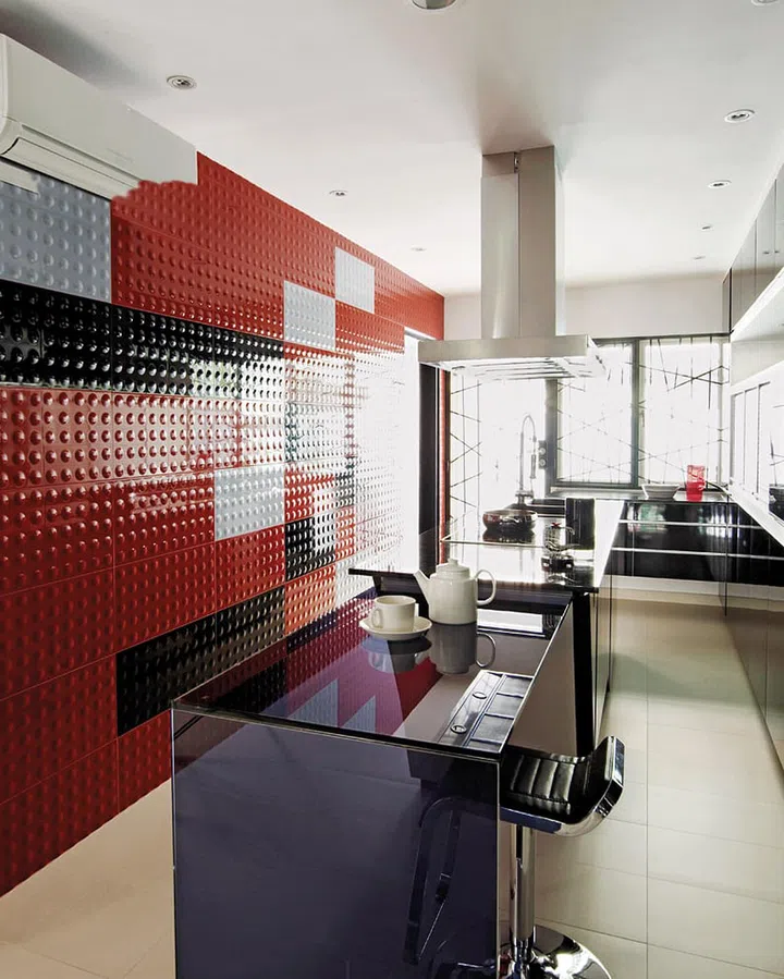 A contemporary red, black and white corner terrace (Reno $180,000). The designer considered several options for a feature wall in the dry kitchen: broken slate, wallpaper or brick. He then came across a glossy, textured ceramic tile, and created a mural with black, grey and red pieces. (Reno: $180K, excluding furnishings)