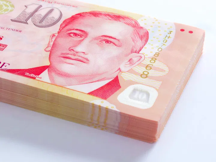 Close up of a stack of Singapore dollar money.