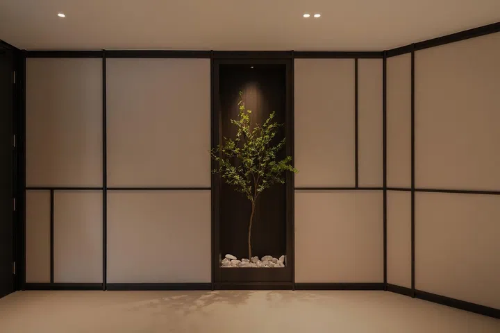 Large-format floor tiles with minimal grout lines create an almost continuous surface, helping the apartment feel more spacious while allowing the architectural detailing to take centre stage.