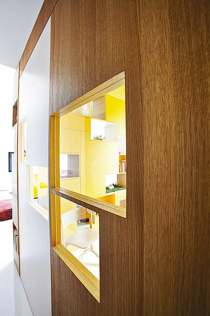 If you want a room that is enclosed, but not cut off from the rest of the home, incorporate "cut out" openings in a random yet neat pattern, as seen here.