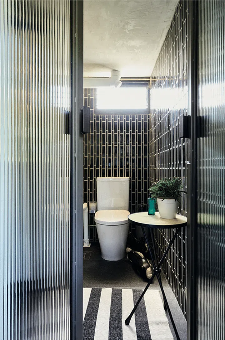 The couple chose these black Art Deco-inspired tiles for their green tint to them; it was to echo the lush greenery surrounding their HDB block.