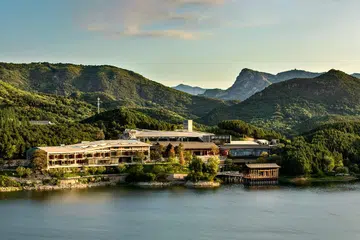 Bird's eye view of the hotel, Yanbai Villa, in the outskirts of Beijing against a green, mountainous landscape. Image from Small Luxury Hotels Yanbai Villa website.
