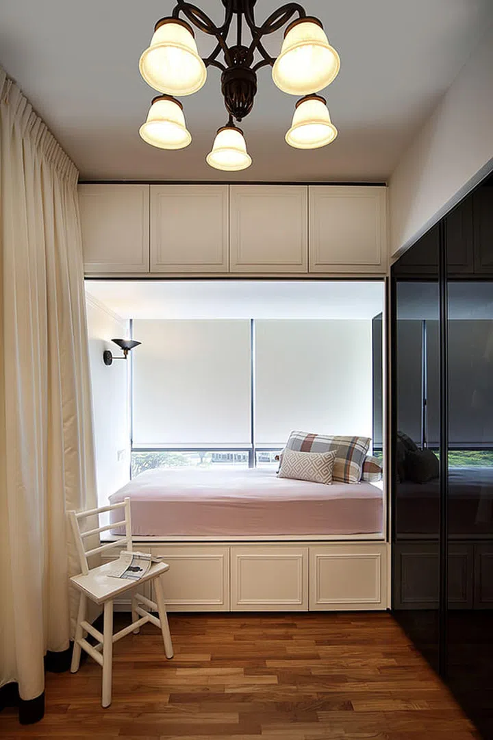 A pink bay window bed with storage cabinets in an apartment at The Interlace condominium.