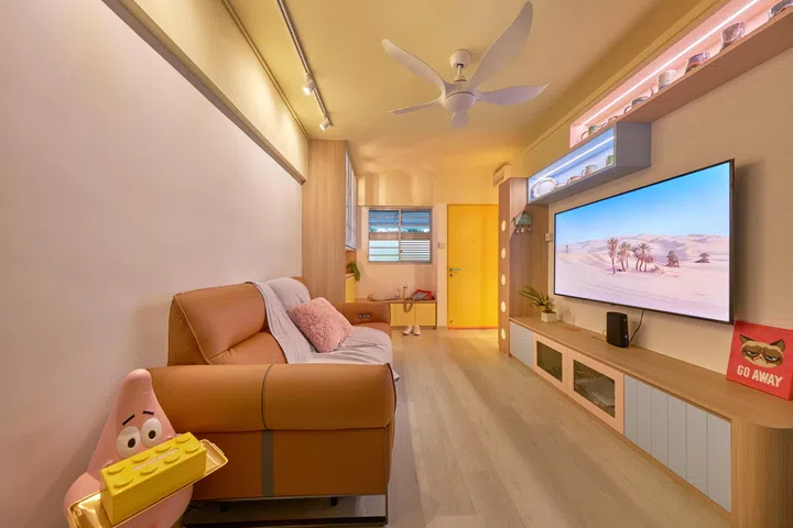 Vinyl floors in the living room blend in with the light wood TV console and pastel shades.