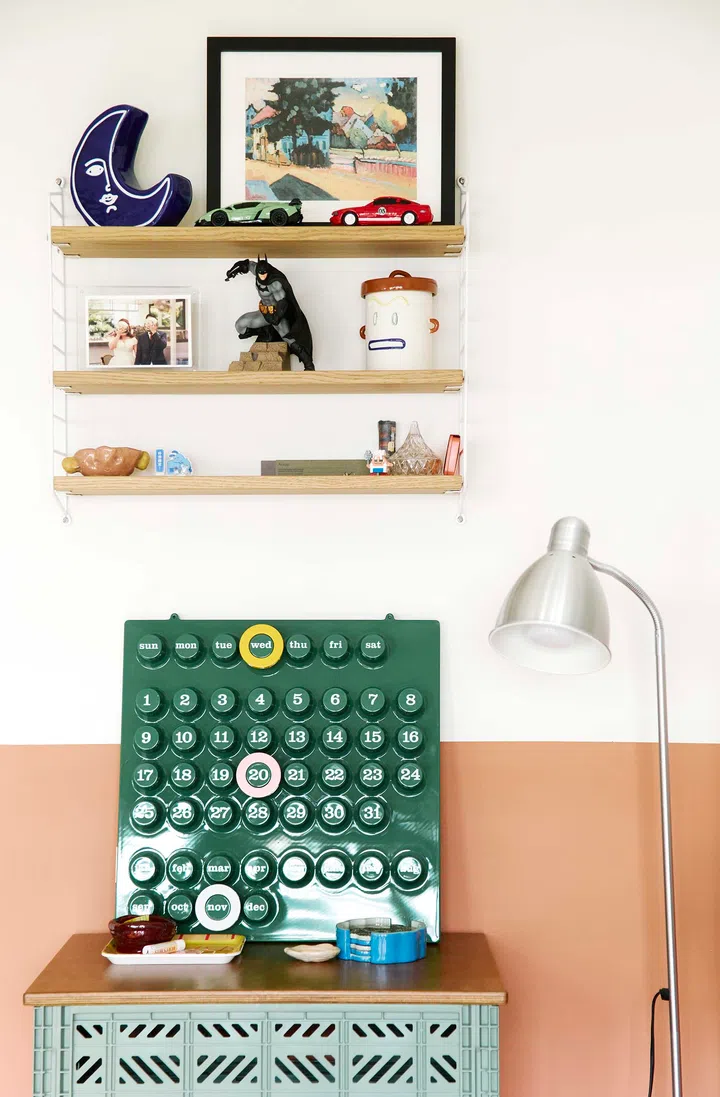 A shelf in the living room showcasing an adorable collection of colourful toys and playful objects.