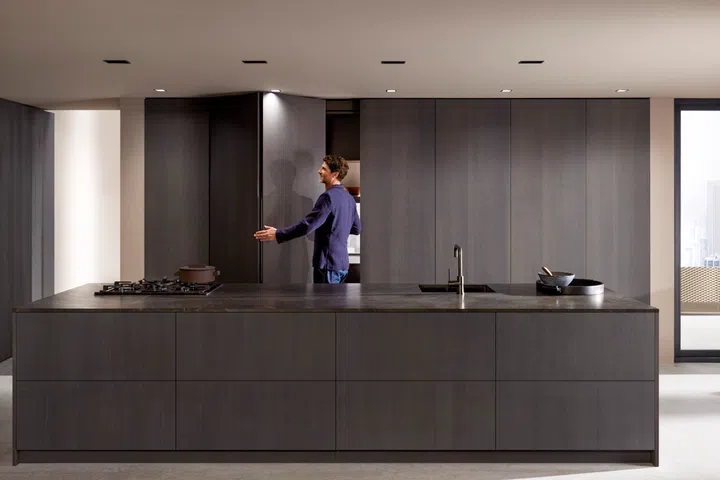 Revego's innovative system allows large cabinet fronts to be folded away, revealing additional storage or utility space within. 