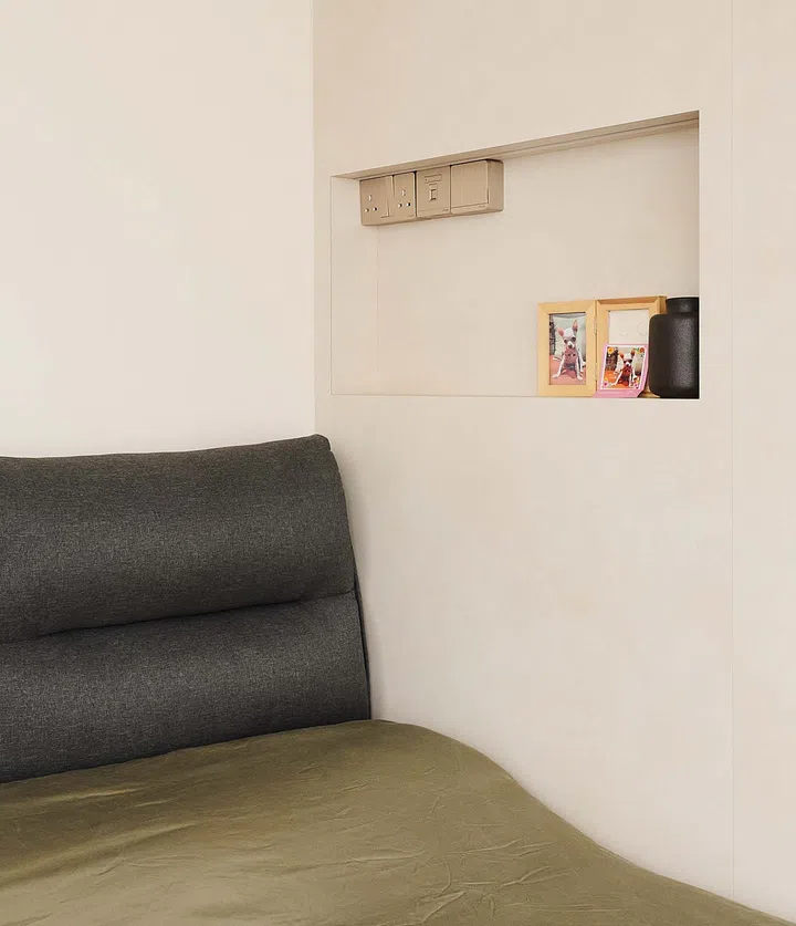 Custom-designed master bed with built-in bedside ledge seamlessly integrated into the wall, inspired by luxury hotel aesthetics for a sleek yet practical setup.